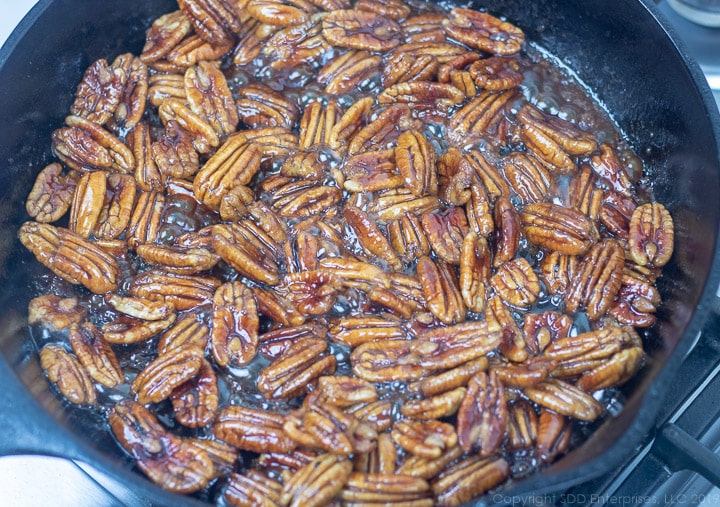 pan roasting pecans in rum and cane syrup for glazed pecans