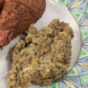 oyster dressing on a plate with a turkey leg