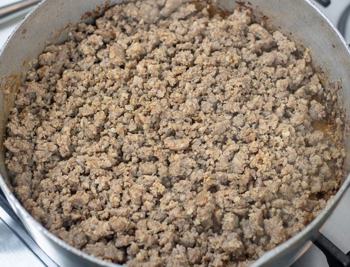 browned pork sausge in a frying pan for oyster dressing