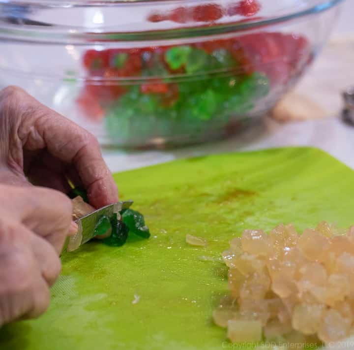 chopping candied fruit and placing them in a bowl