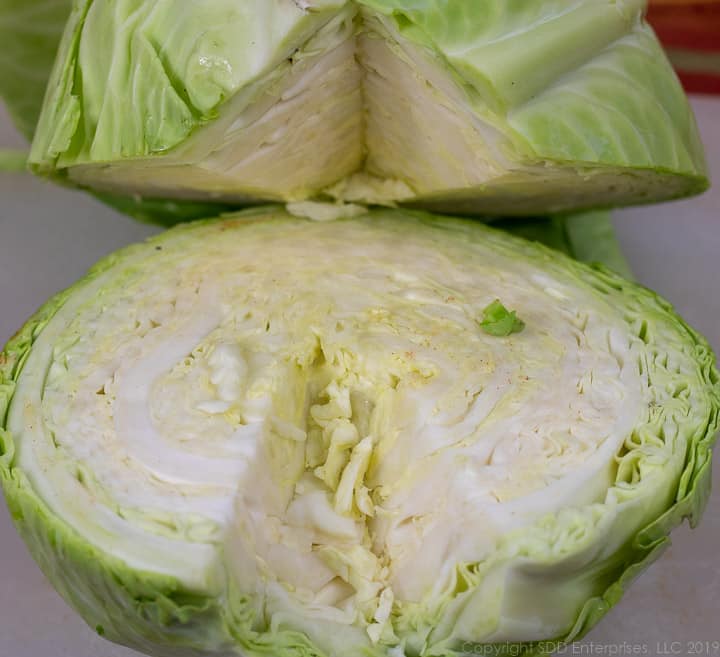 head of cabbage sliced in half and the stem removed
