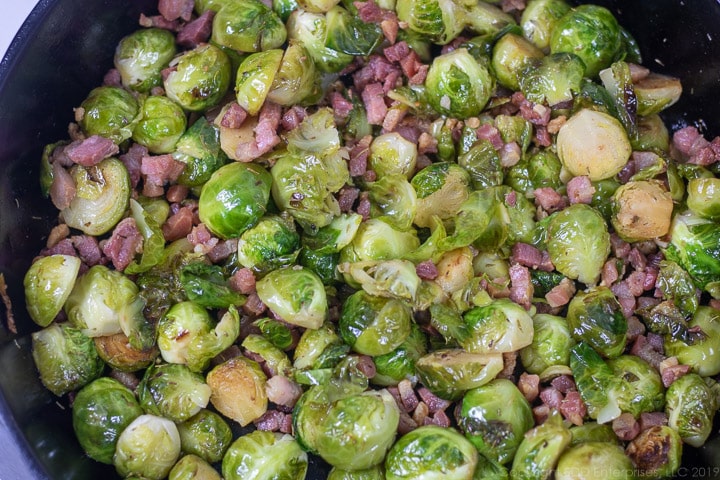 roasted brussels sprouts with pancetta in a cast iron frying pan