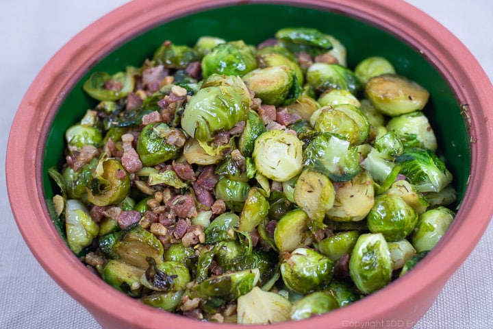 roasted brussels sprouts with pancetta in a brown bowl