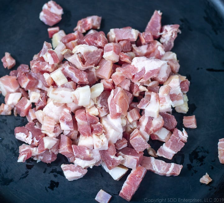 chopped pancetta in a cold cast iron pan