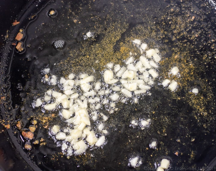 chopped garlic in the pancetta fat in a cast iron pan