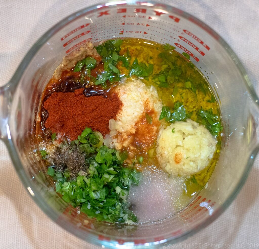 all ingredients for shrimp remoulade sauce in a measuring cup