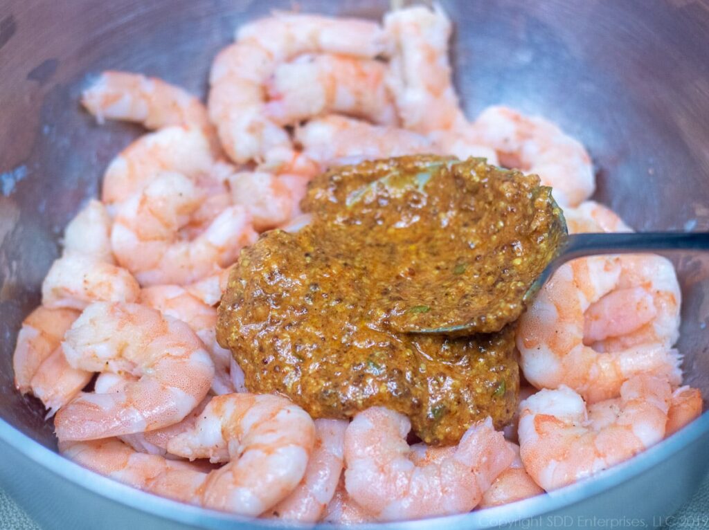mixing remoulade sauce with chilled shrimp for shrimp remoulade