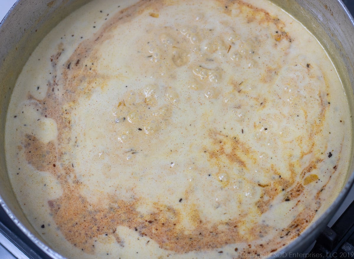 heavy cream and lemon juice added to the onions, wine and spices in a frying pan