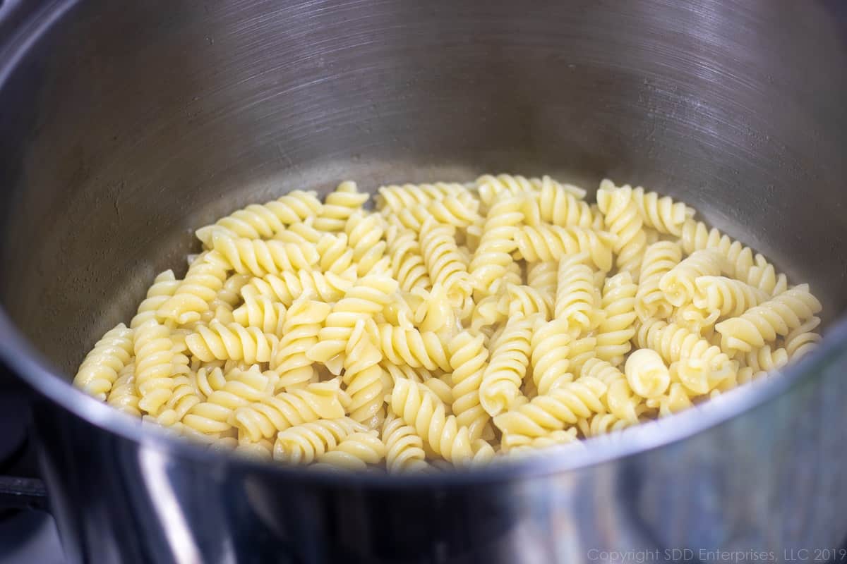 cooked rotini pasta in a stock pot