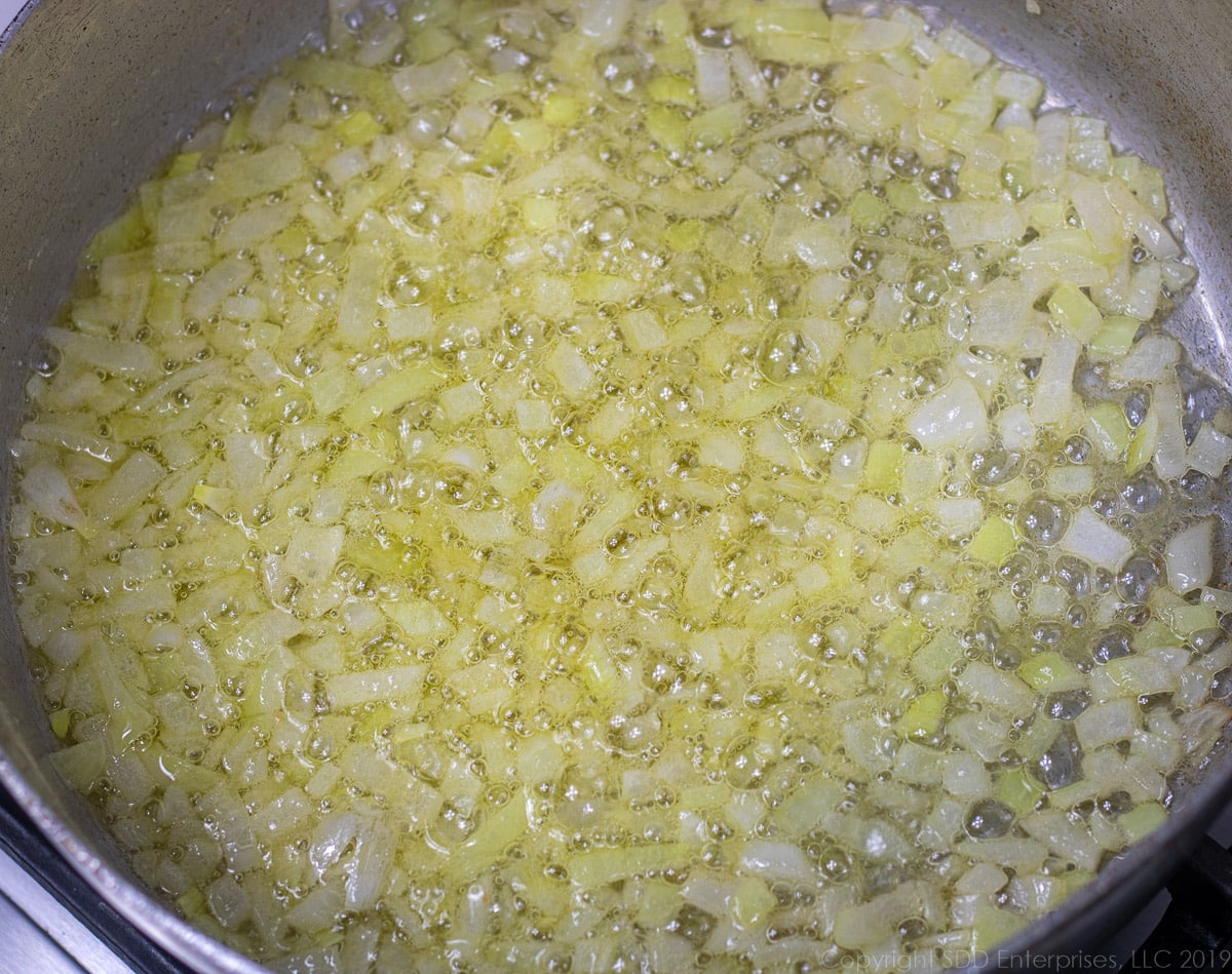 yellow onions and garlic cooking in butter