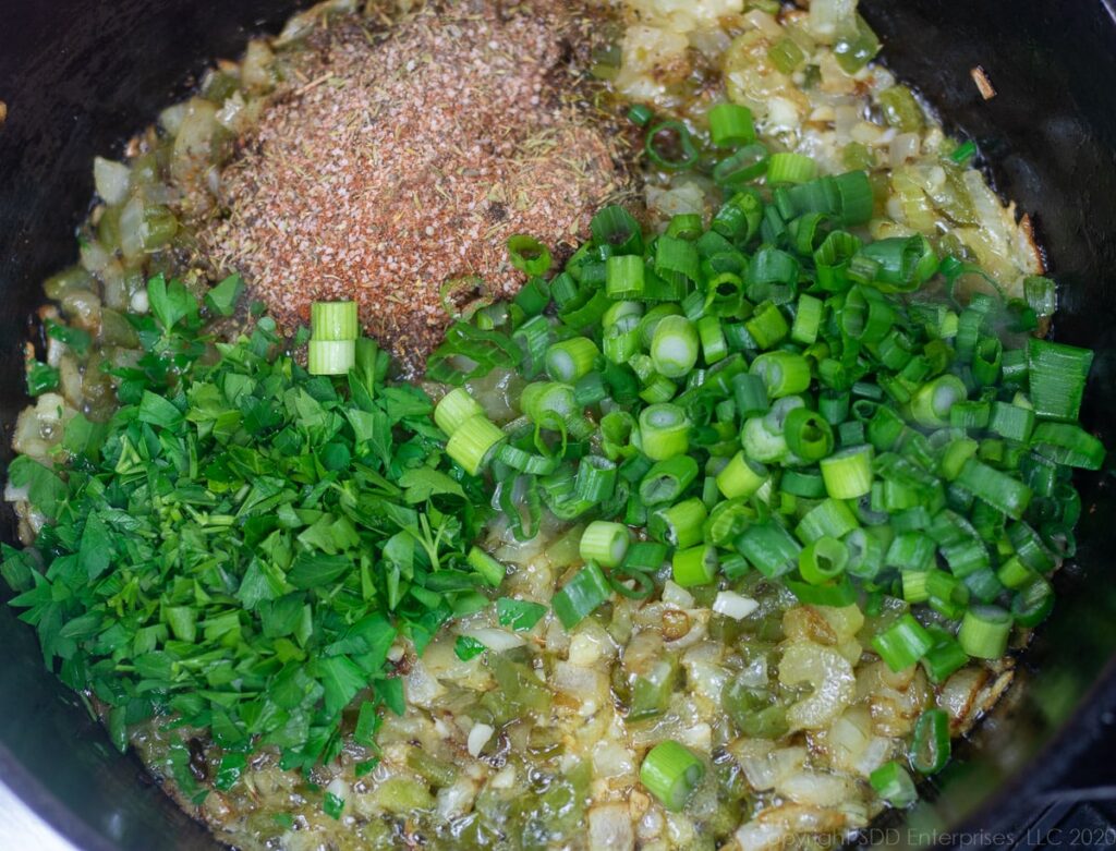 spices, green onions and parsley added to cooking trinity in butter