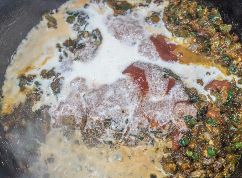 heavy cream, tomatoe sauce and wine added to cooking vegetables in a dutch oven