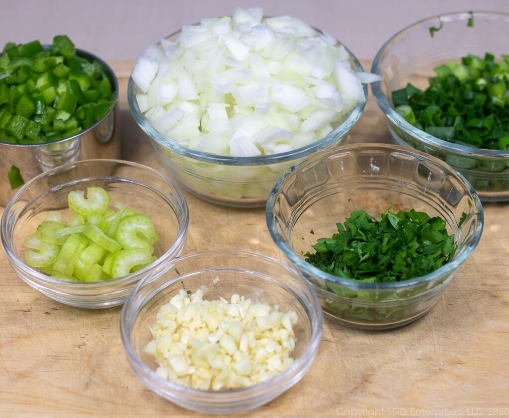 chopped vegetables for crawfish pie in small bowls