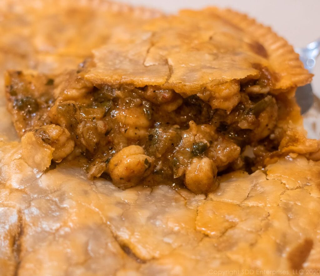 crawfish pie with a slice being removed