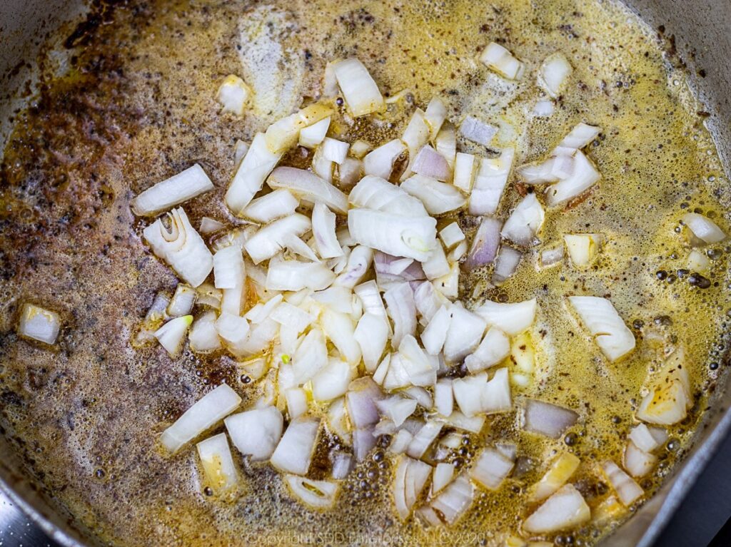 chopped shallots in butter in a frying pan