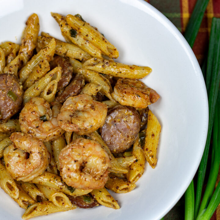 pasta with shrimp and sausage in a white bowl