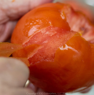 Peeling a parboiled tomato.