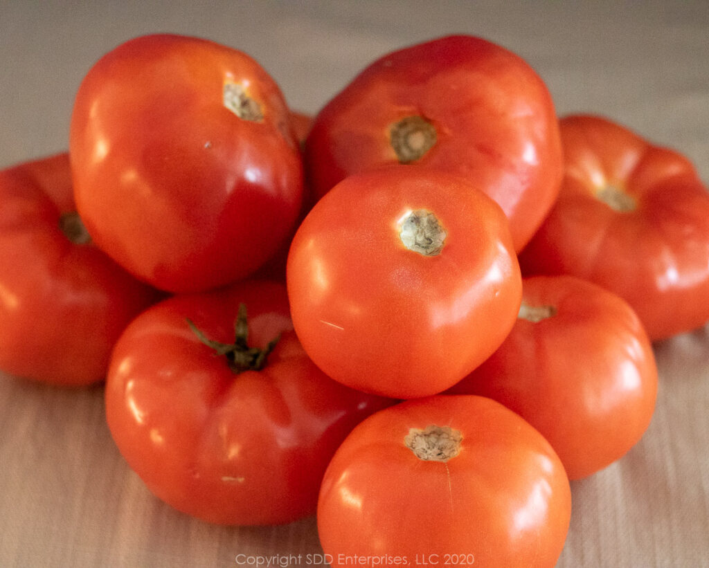 9 ripe tomatoes in a pile