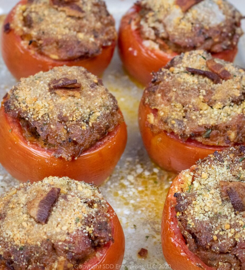 six baked stuffed tomatoes in a baking dish