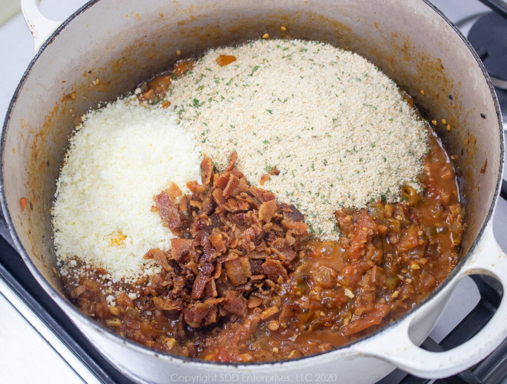 bread crumbs, bacon and romano cheese added to tomato mix in dutch oven