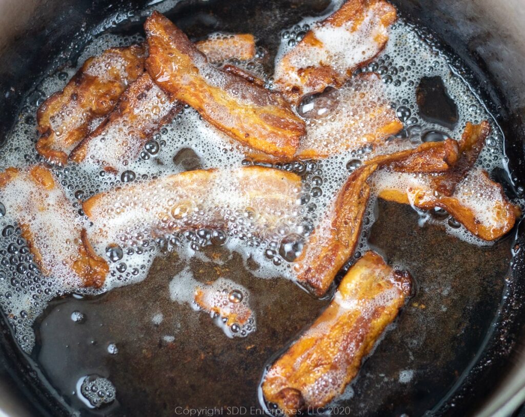 bacon frying in a dutch oven