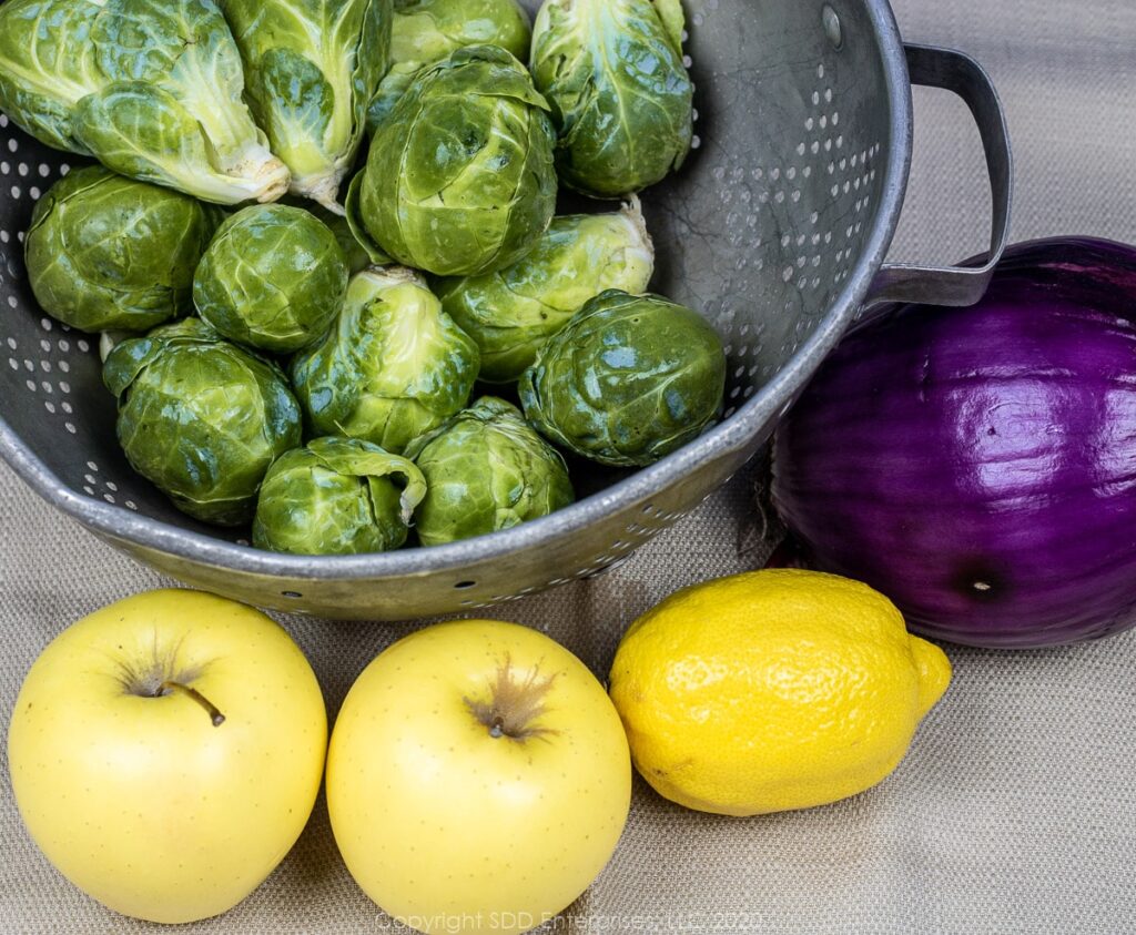 brussels sprouts, red onion, 2 golden delicious apples and a red onion