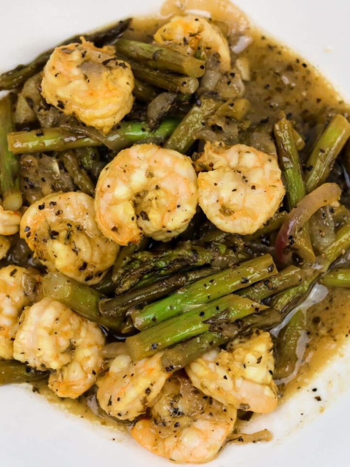 sauteed shrimp with asparagus in a white bowl