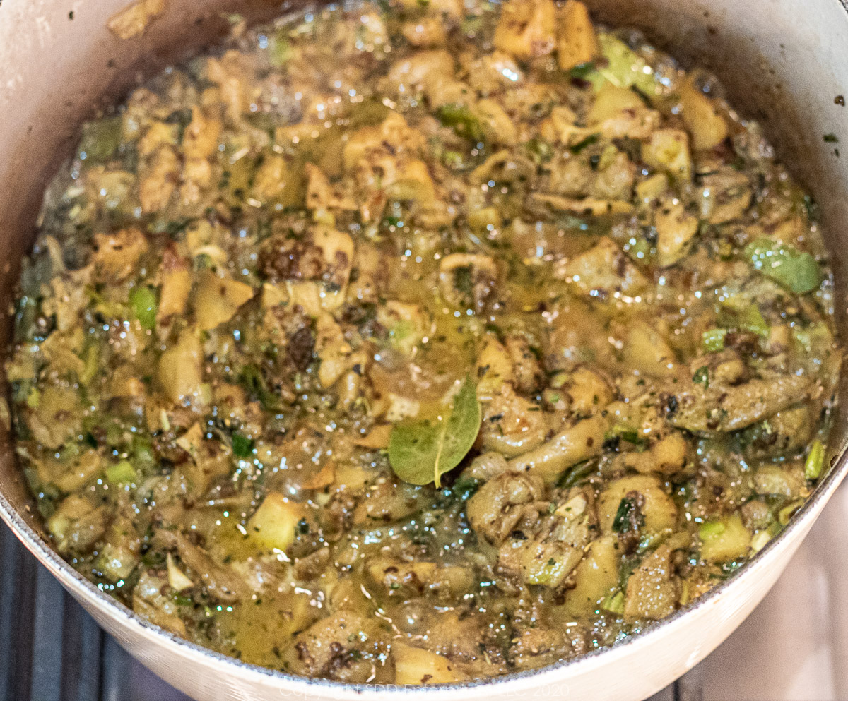 chopped eggplant smothering with onions, bell peppers and celery in a dutch oven