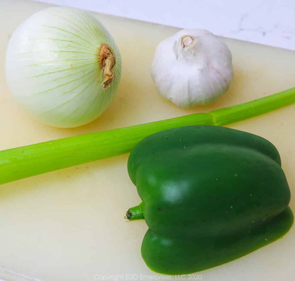 hafl a bell pepper, yellow onion, stalk of celery and a pod of garlic