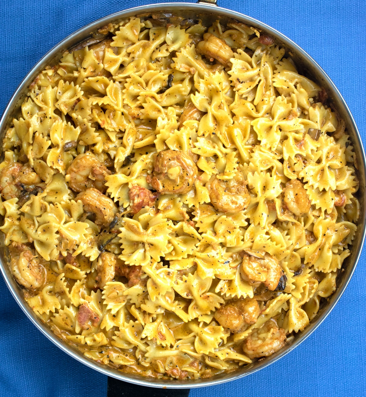 creamy shrimp pasta with mushrooms in a frying pan