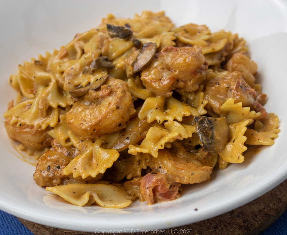 creamy shrimp pasta in a white bowl