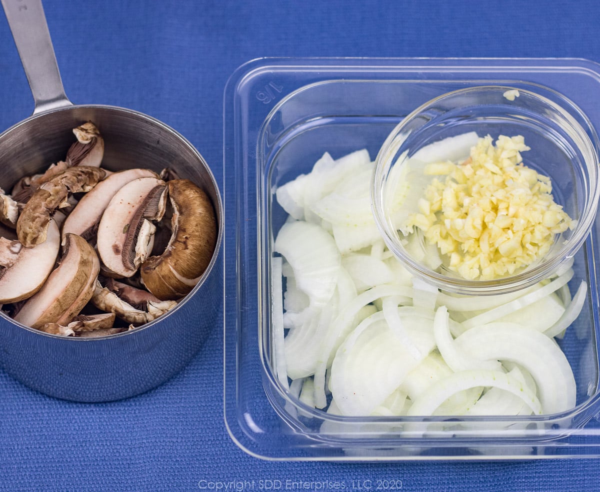 sliced mushroon, onions and chopped garlic in prep bowls