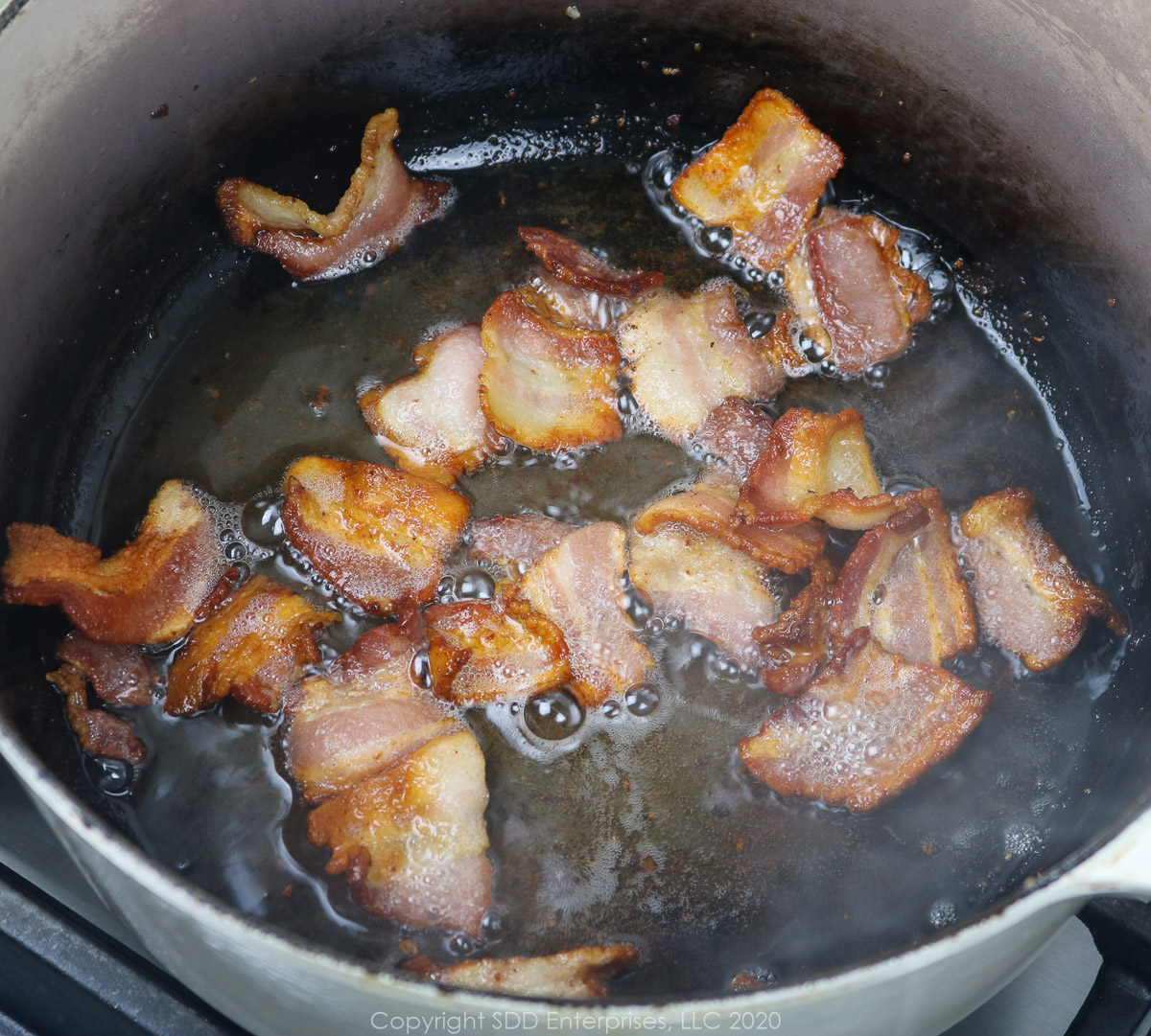 bacon frying in a dutch oven