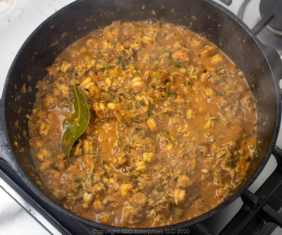 crawfish mixture reduced in a dutch oven for stuffed peppers