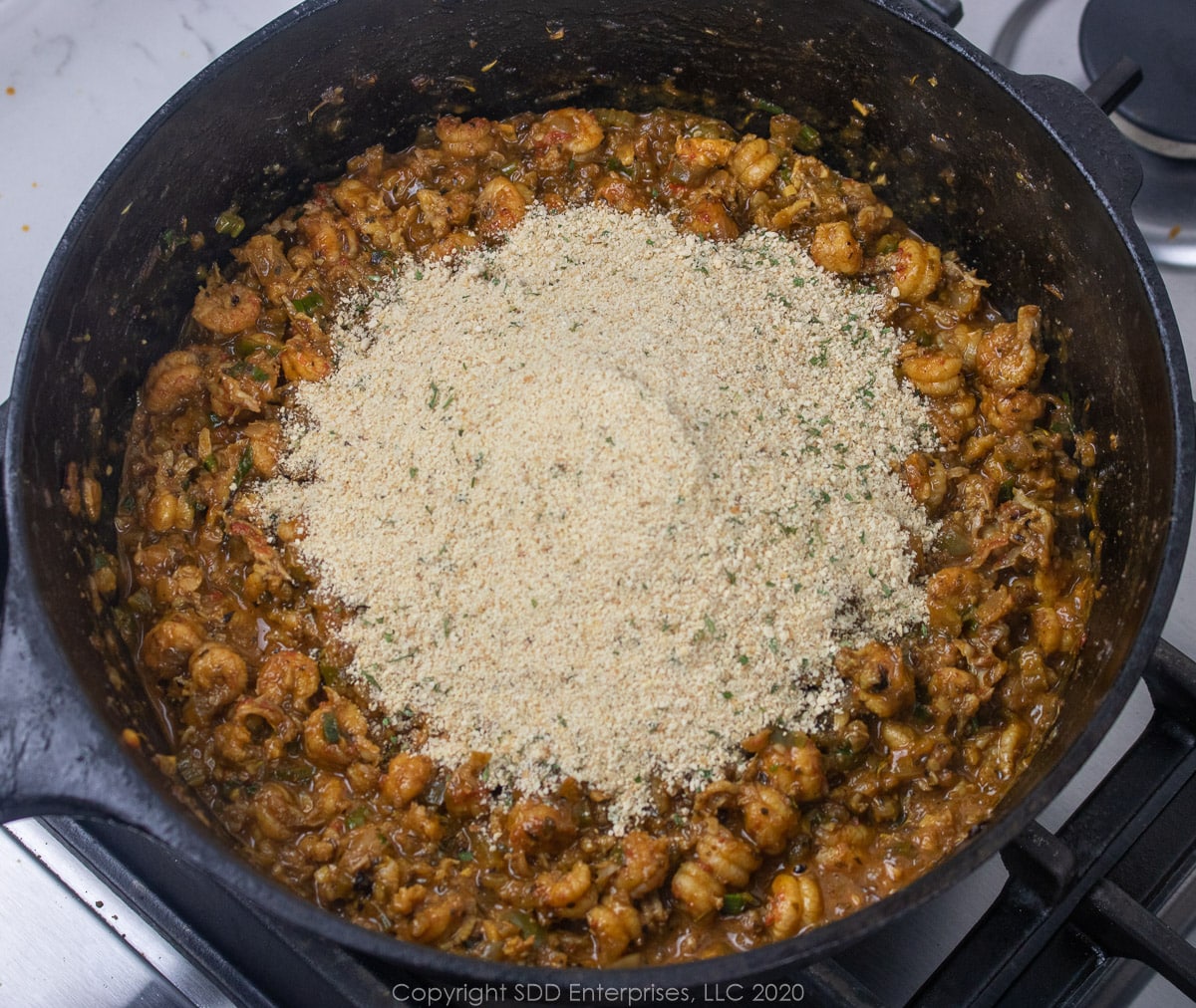 breadcrumbs added to crawfish mixture for cajun stuffed peppers