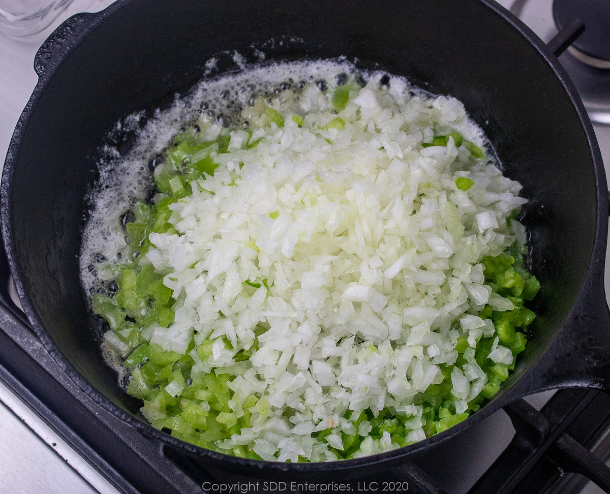 cajun trinity added to butter in a dutch oven