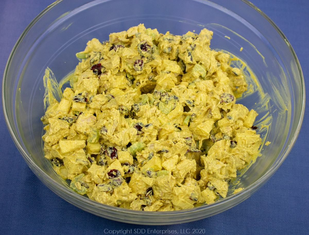 chicken salad with lemon curry dressing in a clear bowl