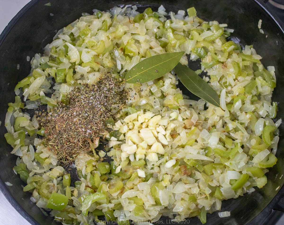 garlic, spices added to the trinity in a cast iron frying pan