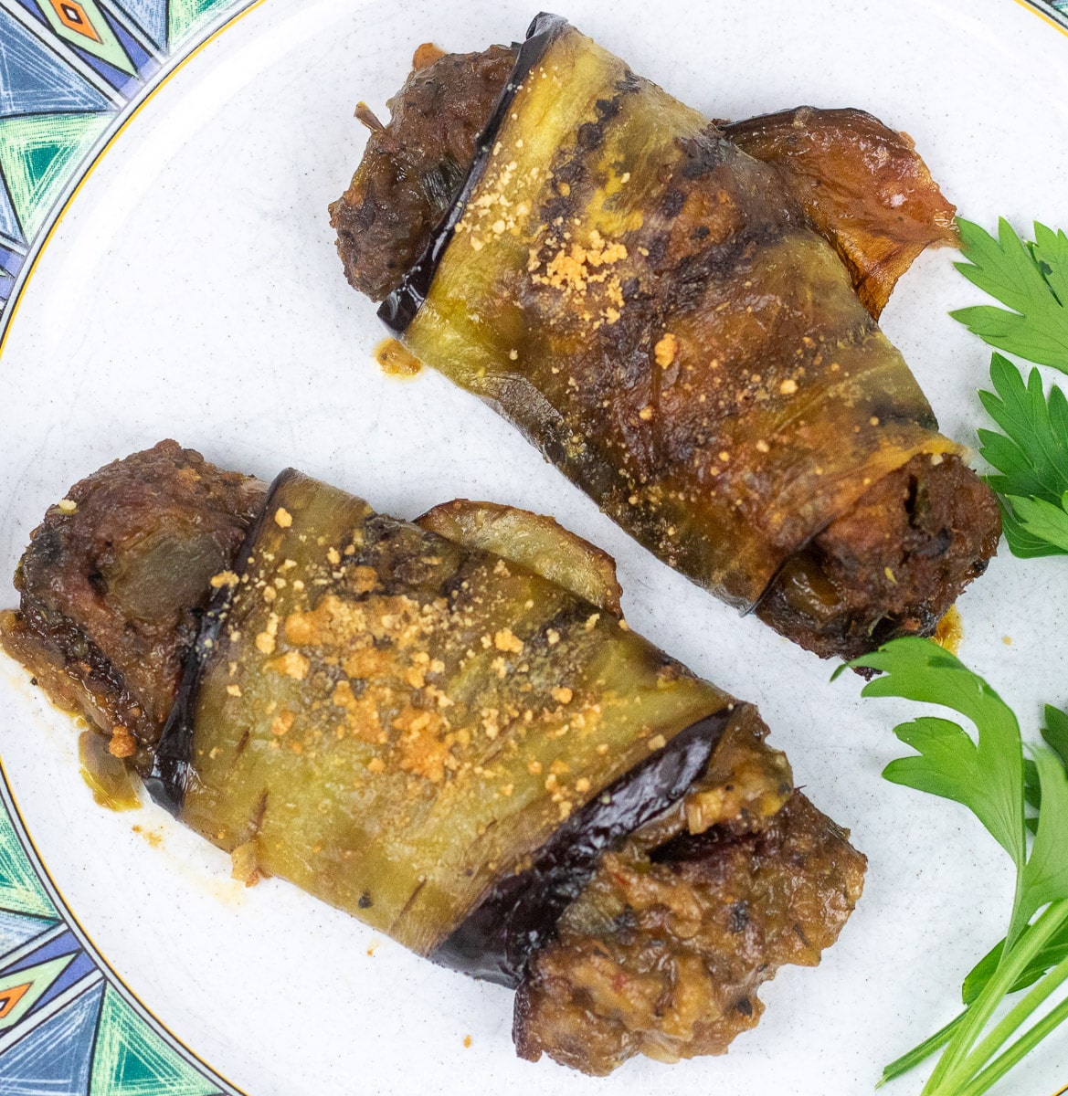 crawfish eggplant rollatini on a plate with parsley garnish