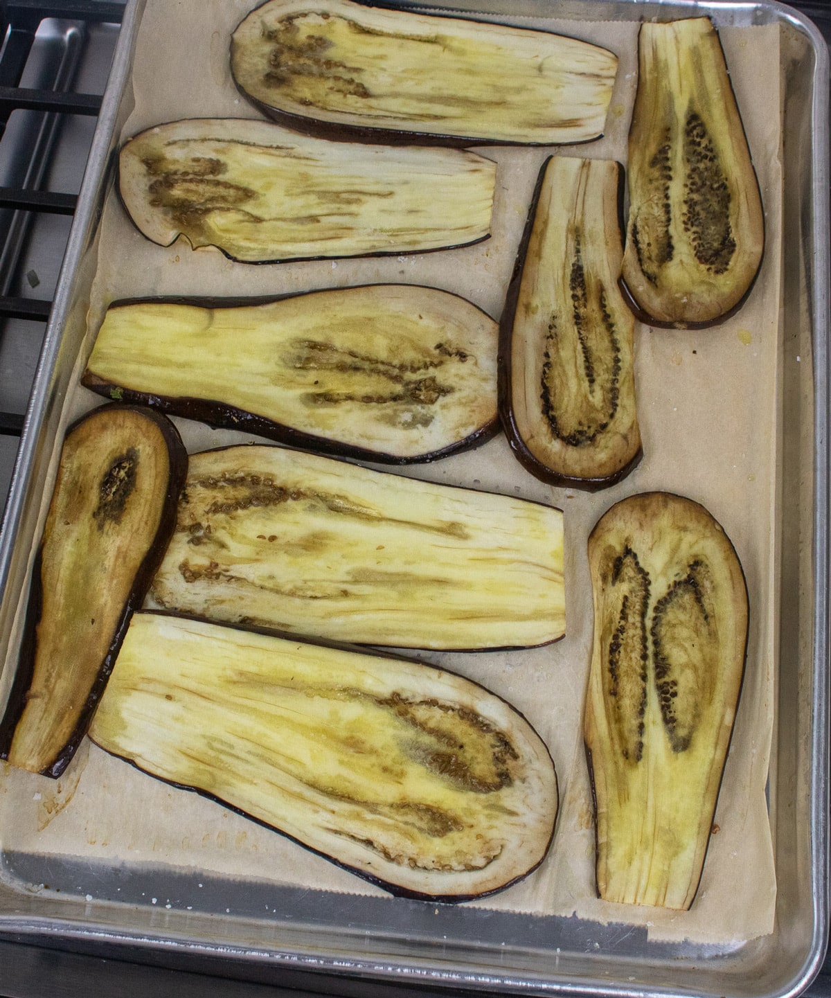 roasted eggplant slices on parchment paper lined baking sheet