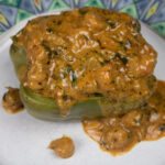 creamy crawfish sauce ladled over a stuffed pepper