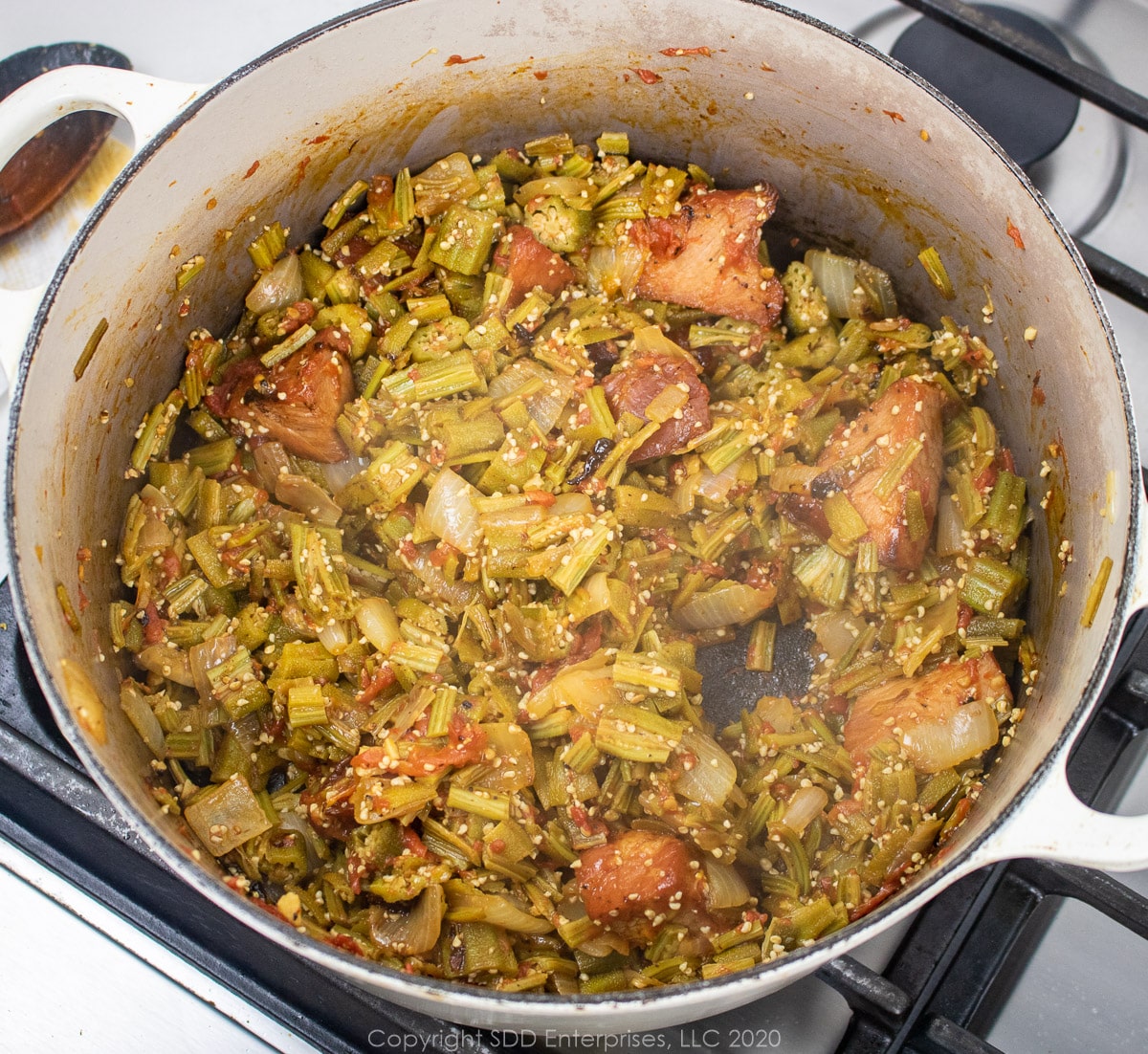 stewed okra with ham and tomatoes in a dutch oven