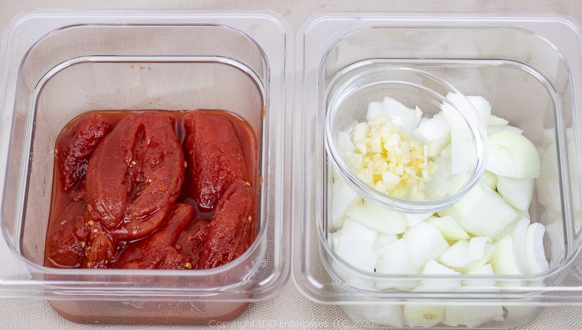 peeled tomatoes, chopped onions and garlic all in individual prep bowls