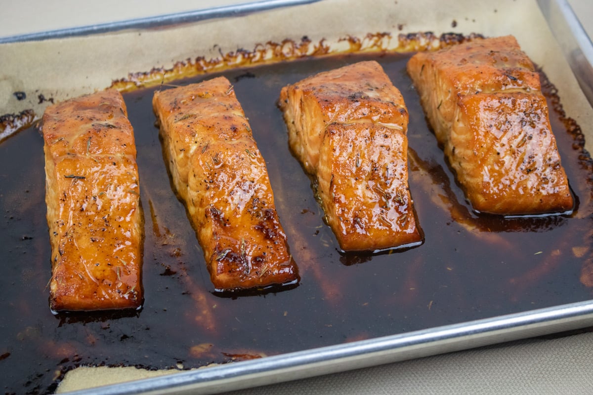 salmon fillets with cane syrup sauce on a baking sheet