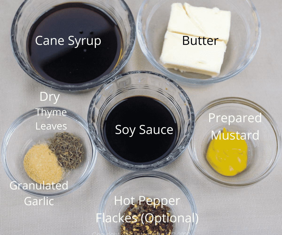ingredients for cane syrup sauce in small prep bowls with labels