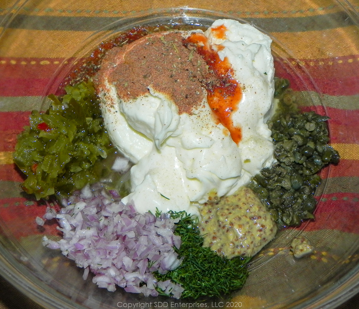 ingredients for creole tartar sauce in a glass bowl