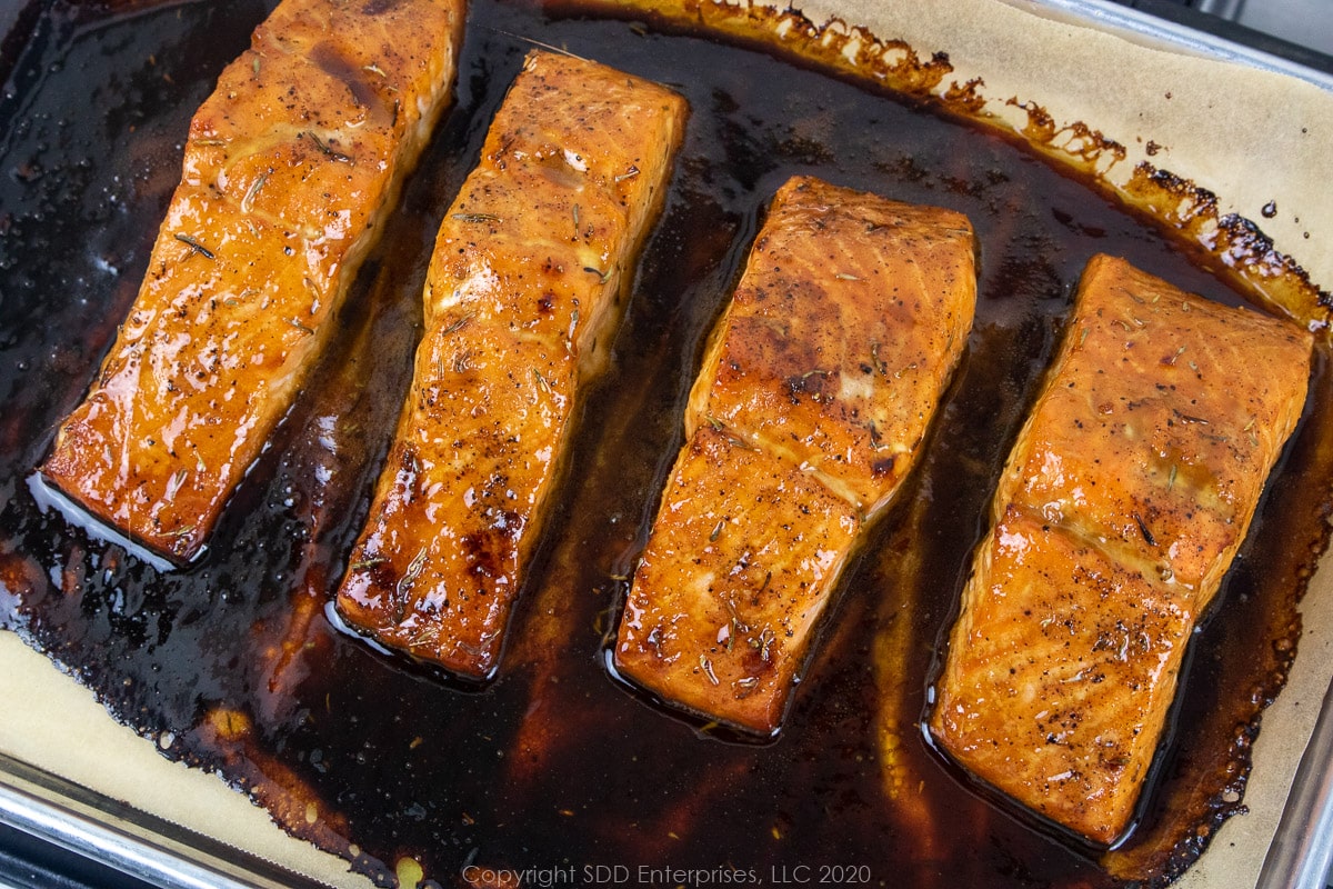 salmon fillets with cane syrup sauce on a baking sheet