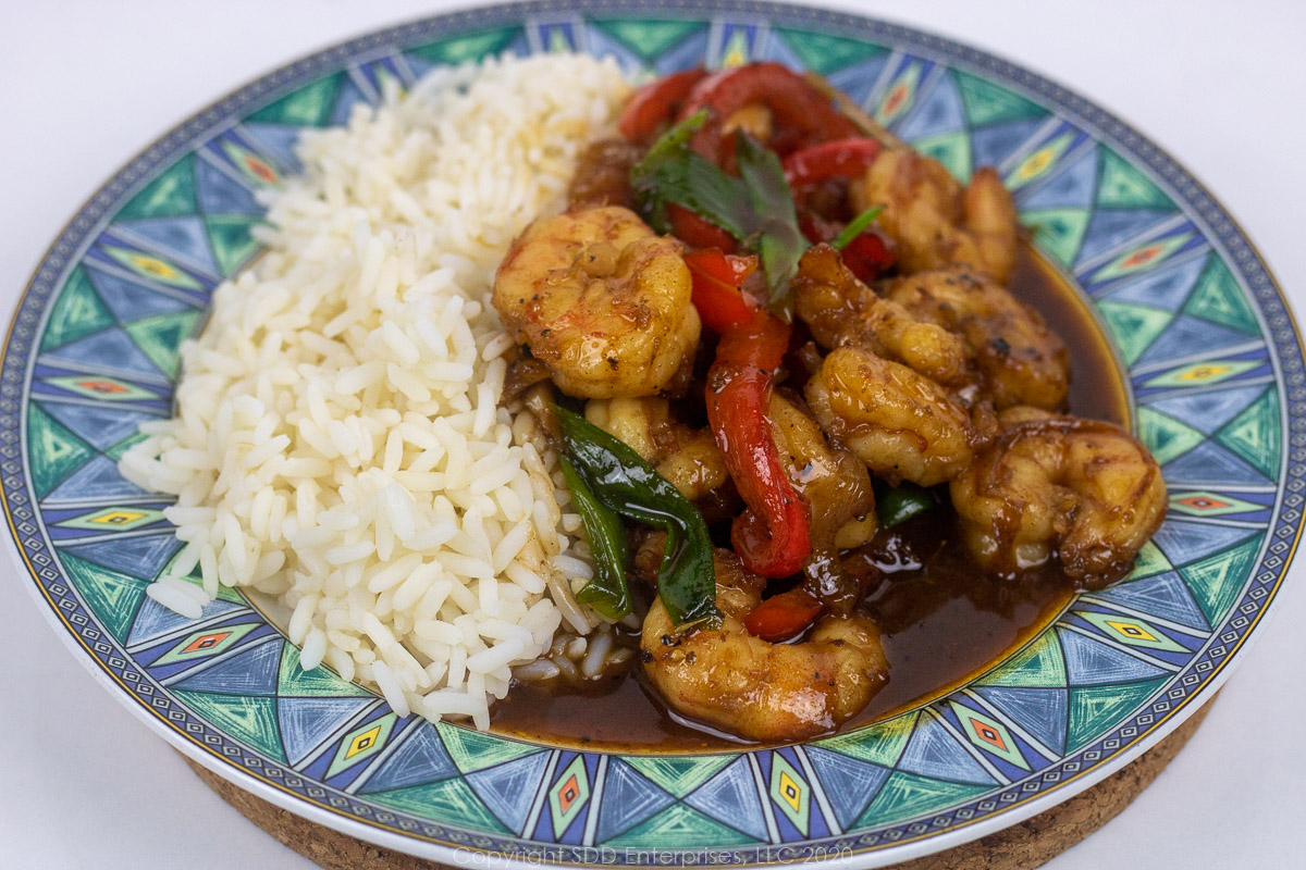 shrimp with cane syrup sauce with rice on a blue and green trim