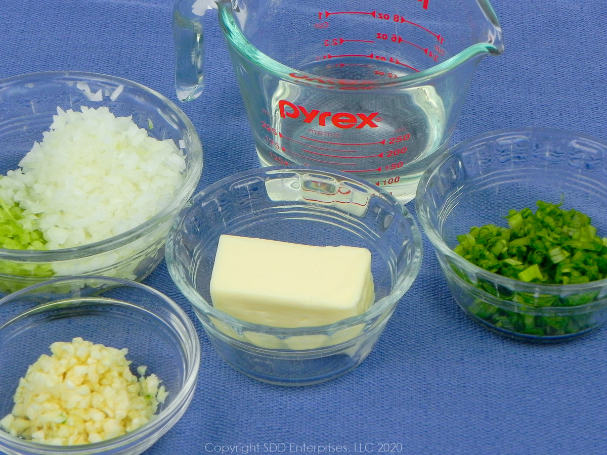 yellow onions, celery, green onions, garlic, butter and white wine in separate prep bowls