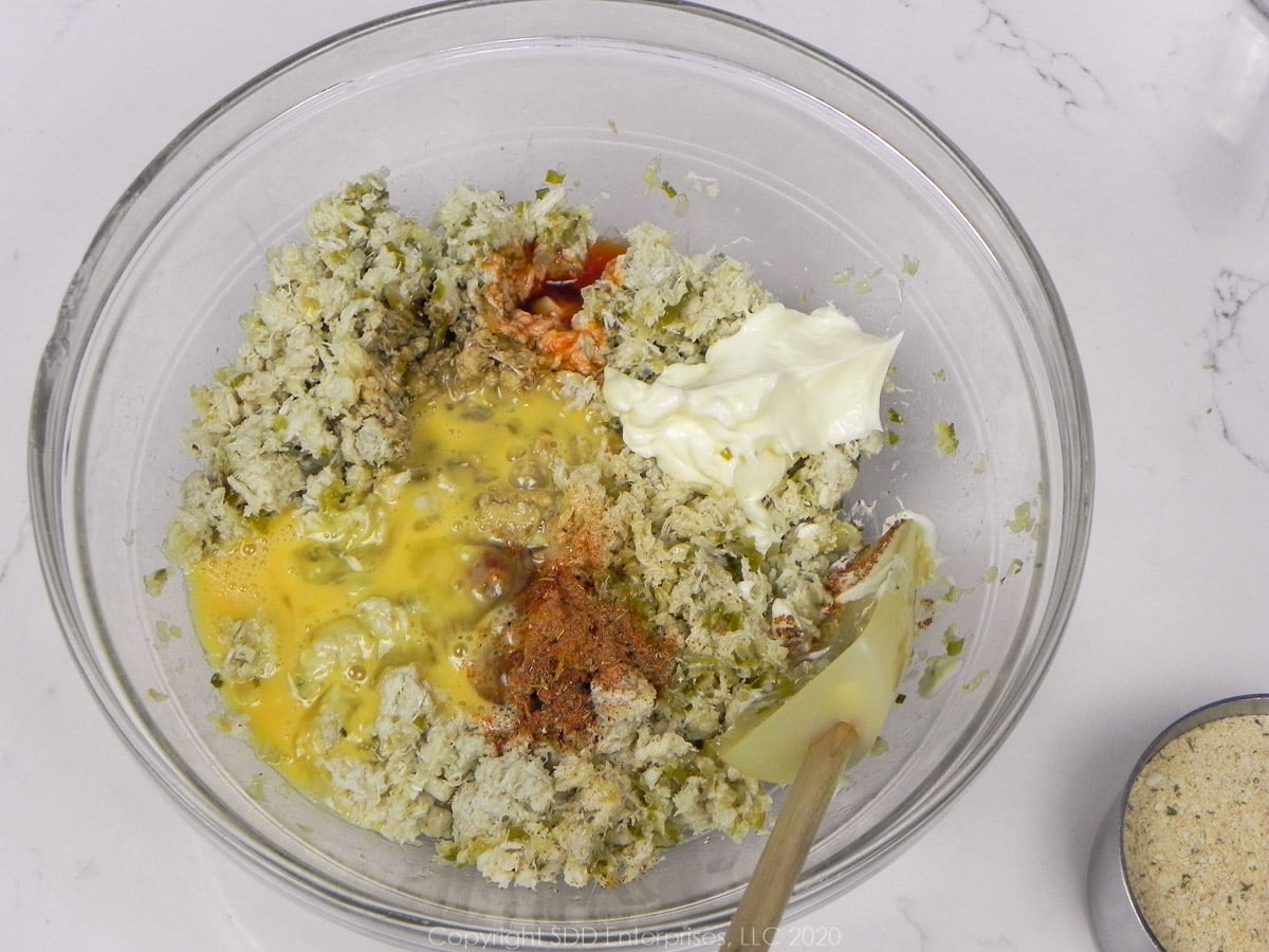 ingredients for crab meat stuffing in a glass bowl